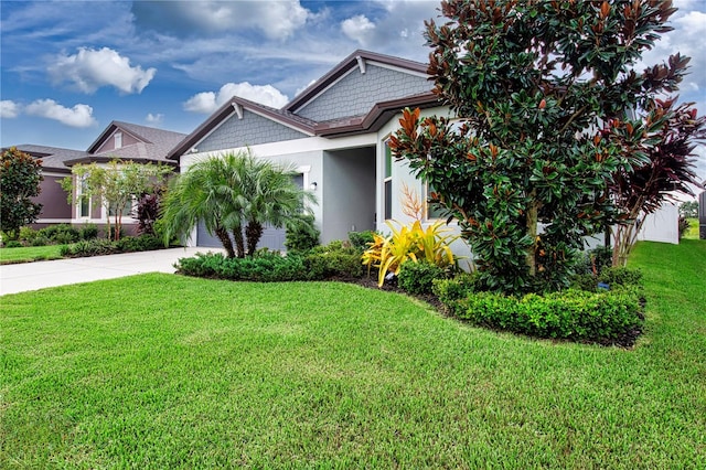 view of front of property with a garage and a front lawn