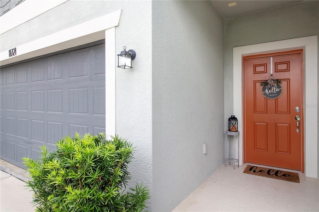 view of exterior entry featuring a garage