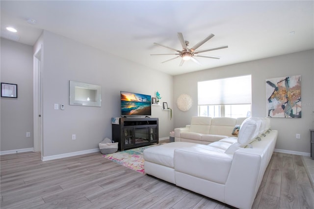 living room featuring light wood-type flooring and ceiling fan