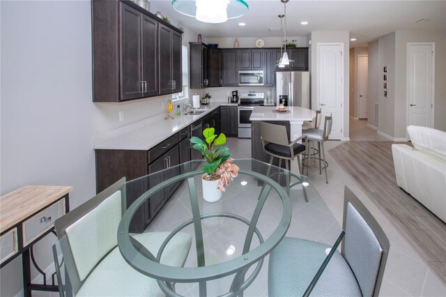 dining area with sink and light hardwood / wood-style flooring