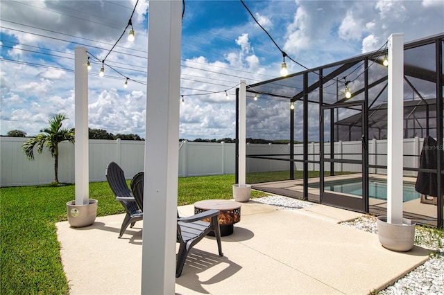 view of patio / terrace featuring a fenced in pool and glass enclosure