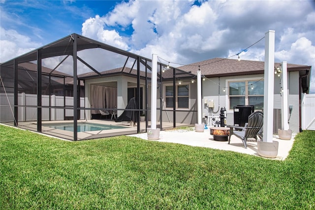 back of property featuring a fenced in pool, a lanai, a patio area, and a lawn