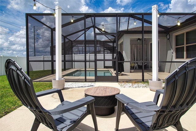 view of patio with a fenced in pool and glass enclosure