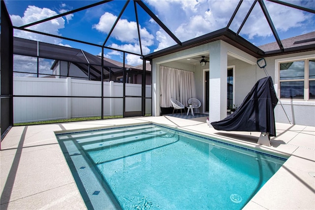 view of pool featuring ceiling fan, a lanai, and a patio area