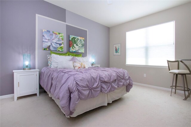 bedroom featuring light carpet