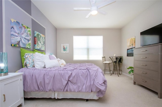 bedroom with ceiling fan and light colored carpet