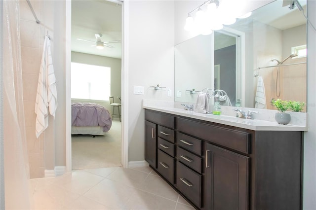 bathroom featuring tile patterned flooring, vanity, ceiling fan, and a tile shower