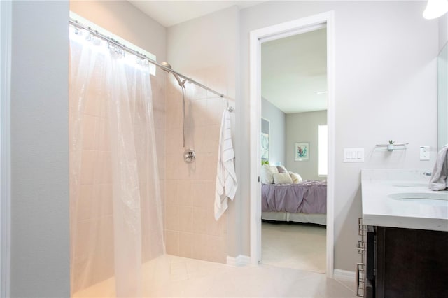 bathroom with tile patterned flooring, plenty of natural light, vanity, and walk in shower