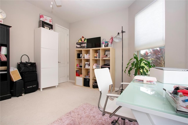 home office with light carpet and ceiling fan