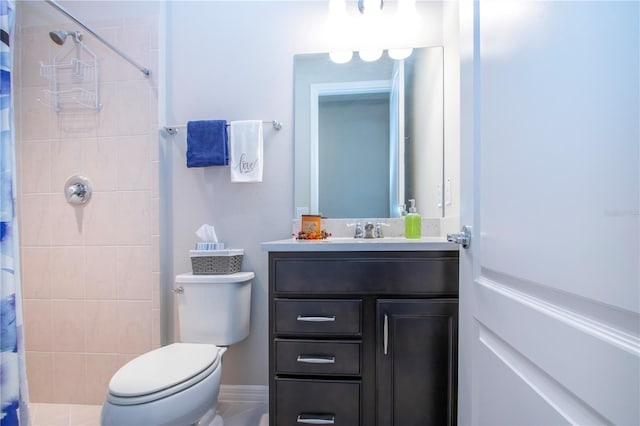 bathroom featuring vanity, toilet, and curtained shower