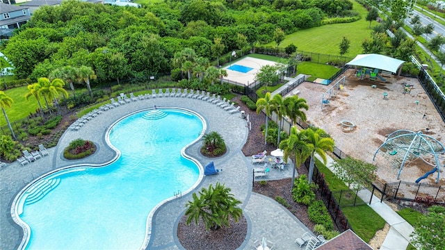 view of pool featuring a patio area and a playground