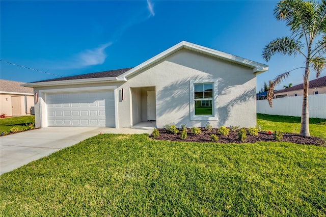 single story home with an attached garage, fence, concrete driveway, stucco siding, and a front yard