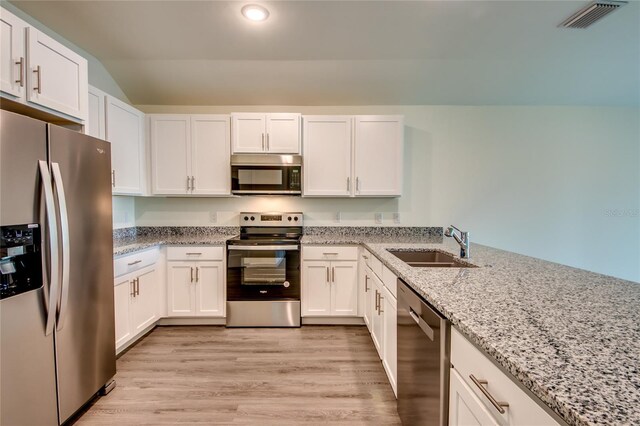 kitchen featuring stainless steel appliances, a sink, visible vents, and white cabinets