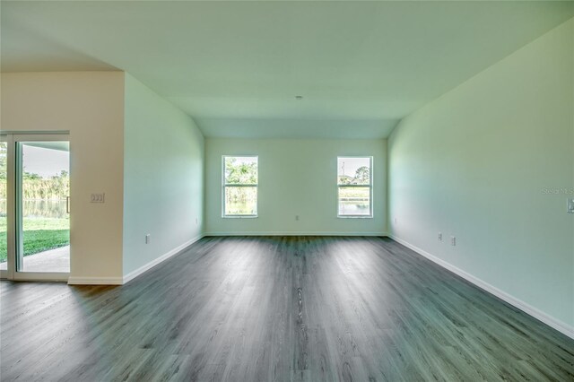 empty room featuring dark wood finished floors and baseboards