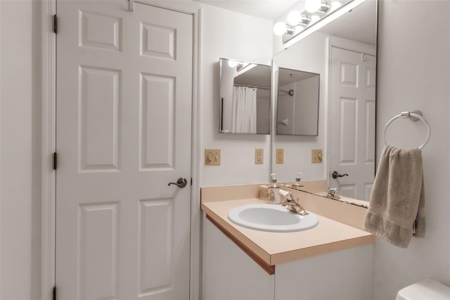 bathroom with toilet and vanity