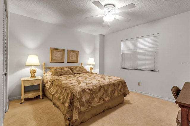 carpeted bedroom with a textured ceiling and ceiling fan