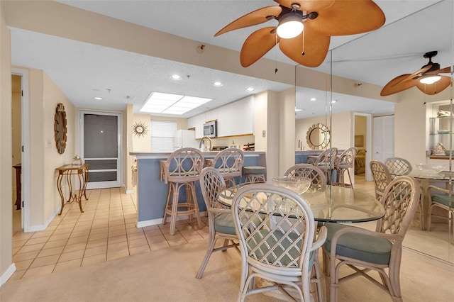 dining room with ceiling fan and light tile patterned floors