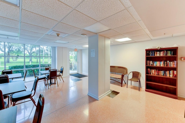 interior space with a paneled ceiling