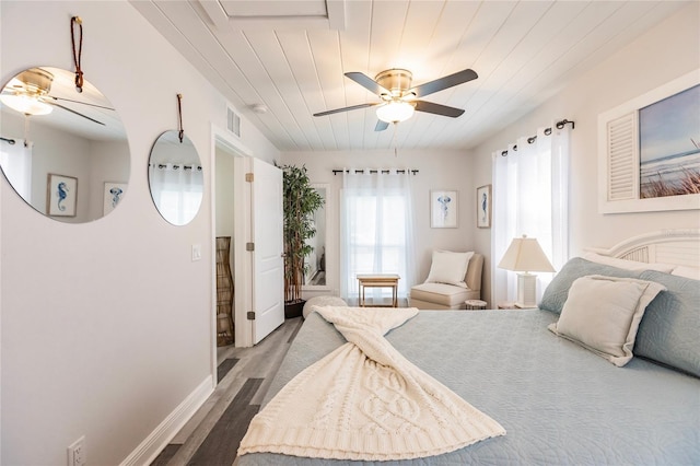 bedroom with wood ceiling, hardwood / wood-style floors, and ceiling fan