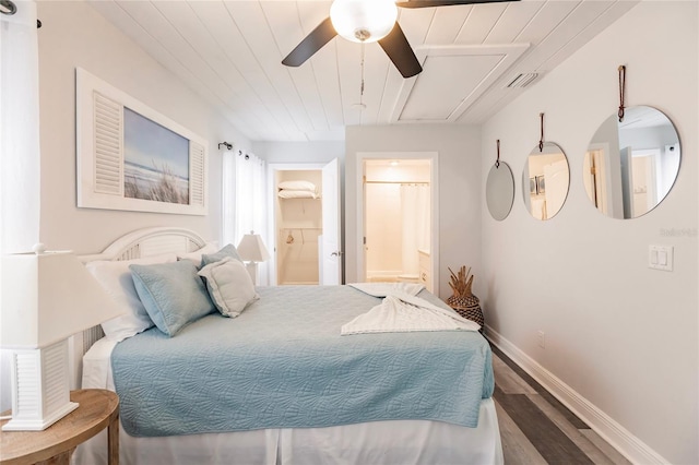 bedroom featuring ensuite bath, dark hardwood / wood-style floors, and ceiling fan