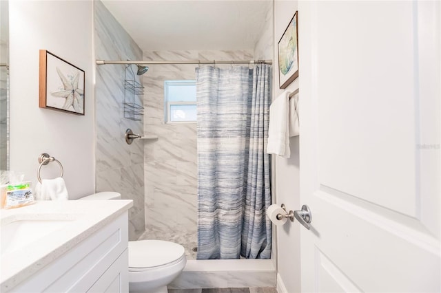 bathroom with vanity, toilet, and curtained shower