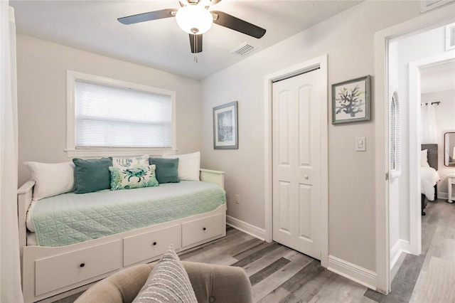 bedroom featuring a closet, ceiling fan, and light hardwood / wood-style flooring