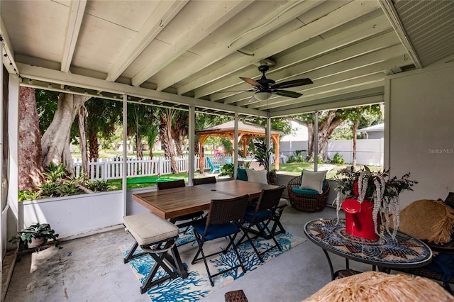 sunroom / solarium featuring ceiling fan