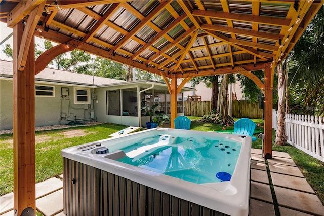 view of swimming pool featuring a hot tub and a gazebo