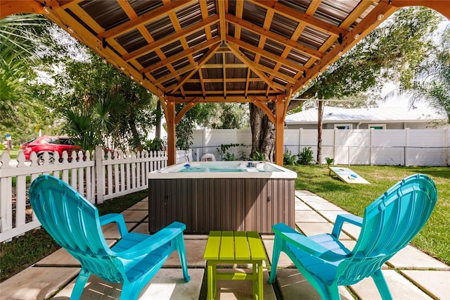 view of patio / terrace with a hot tub and a gazebo