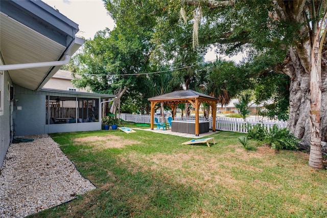 view of yard featuring a sunroom and a gazebo