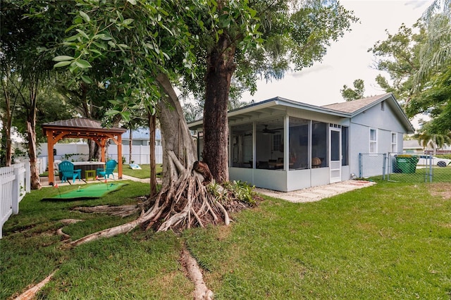 exterior space with a yard, a gazebo, and a sunroom