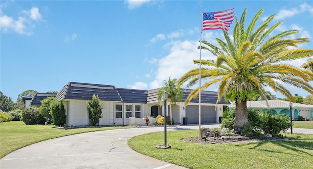 view of front of house with a garage and a front lawn