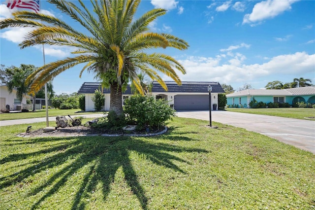 view of front of property featuring a front yard and a garage