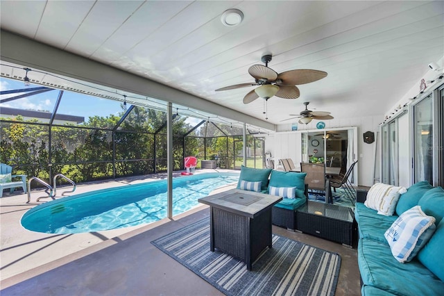 view of swimming pool featuring a lanai, outdoor lounge area, ceiling fan, and a patio