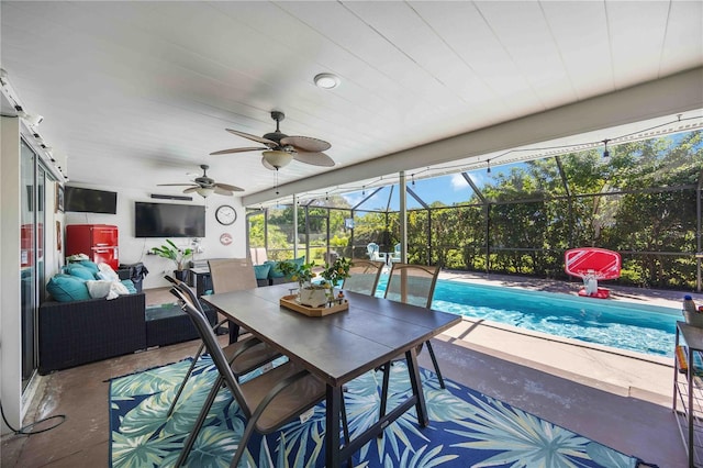 view of patio with outdoor lounge area, ceiling fan, and glass enclosure