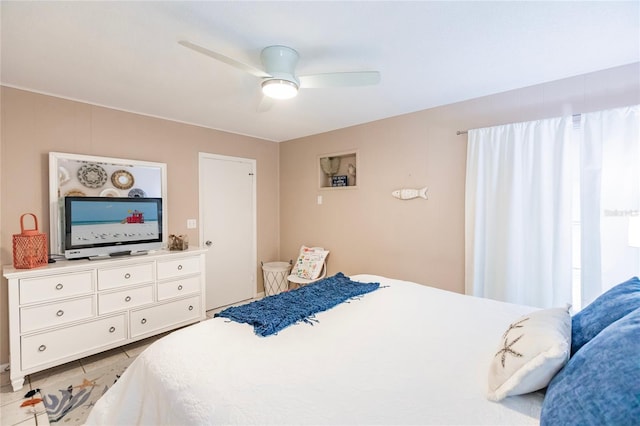 bedroom featuring light tile patterned flooring and ceiling fan