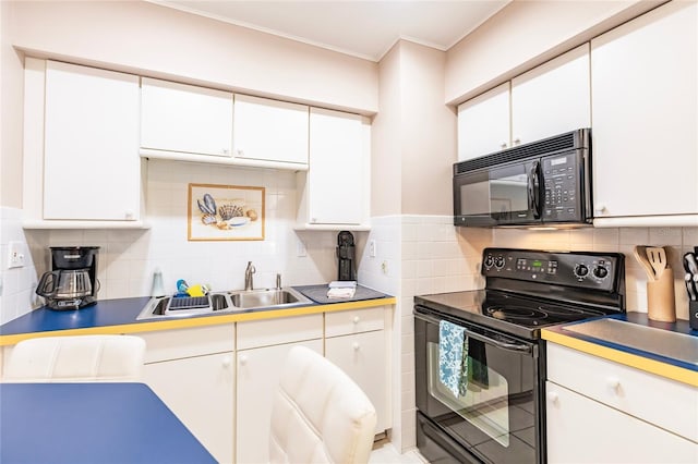 kitchen featuring white cabinetry, tasteful backsplash, black appliances, and sink