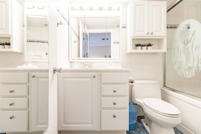 full bathroom featuring toilet, backsplash, vanity, tile walls, and shower / bath combination with glass door