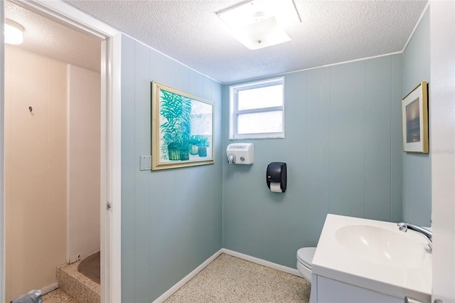 bathroom with toilet, a textured ceiling, and vanity