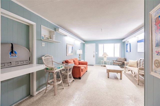 carpeted living room featuring a textured ceiling