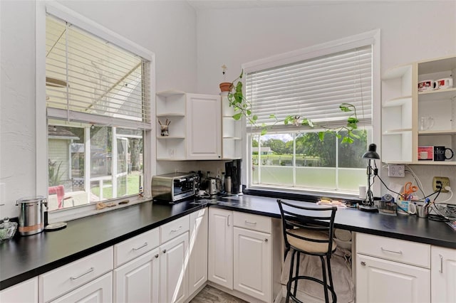 kitchen with white cabinets and plenty of natural light