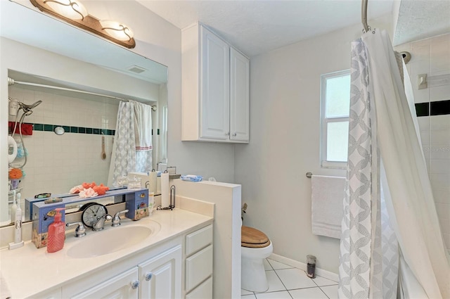 bathroom with tile patterned floors, vanity, curtained shower, and toilet