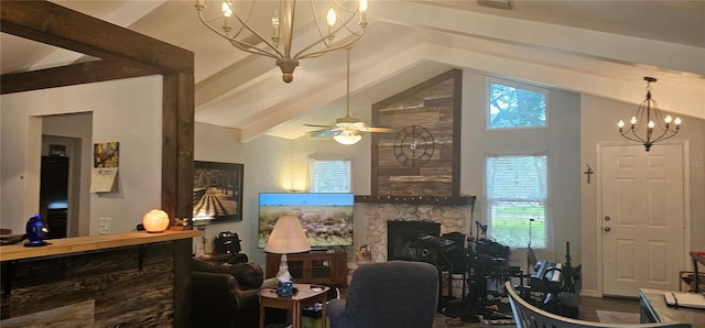 living room with vaulted ceiling with beams, a fireplace, and ceiling fan with notable chandelier