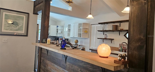 interior space featuring lofted ceiling with beams