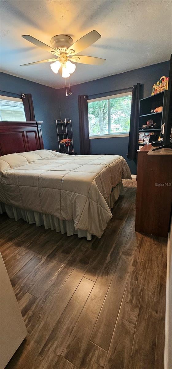 bedroom featuring ceiling fan and dark wood-type flooring