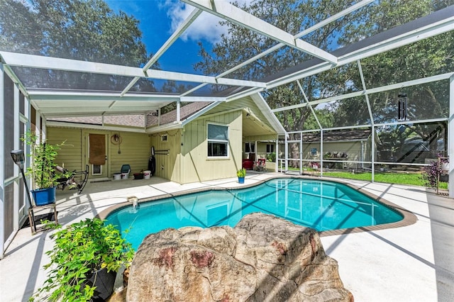 view of swimming pool with a lanai and a patio area