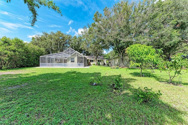 view of yard with glass enclosure