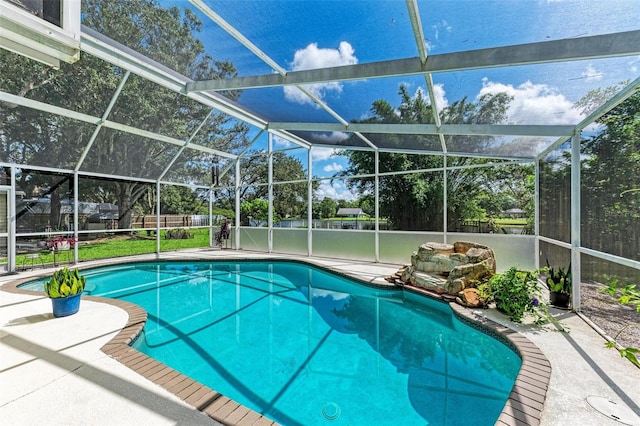 view of swimming pool with a lanai and a patio