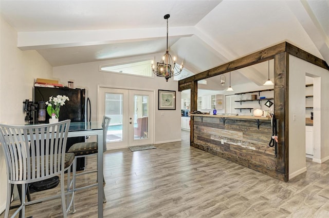 bar with french doors, light wood-type flooring, black fridge, decorative light fixtures, and vaulted ceiling with beams