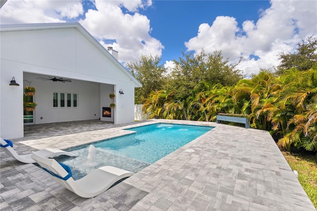 view of pool with ceiling fan and a patio area